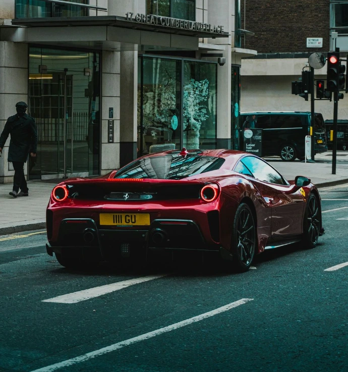 red ferrari 458 italia on road near building during daytime
